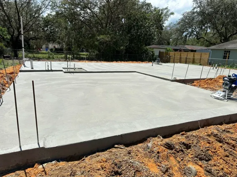 Finished concrete slab foundation with formed edges on a cleared lot, Heritage Pines, FL